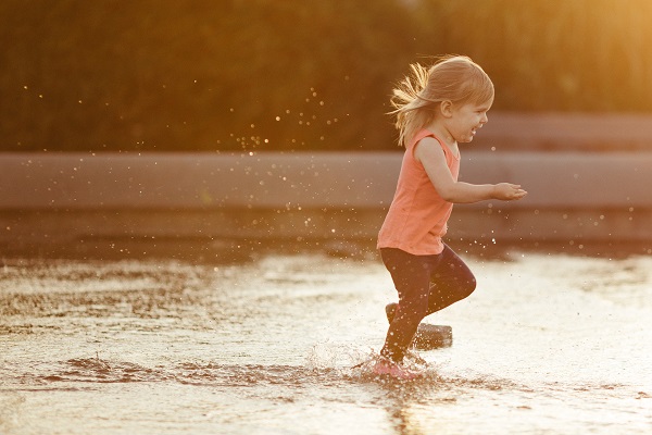 Young girl playing outside battling summer allergies