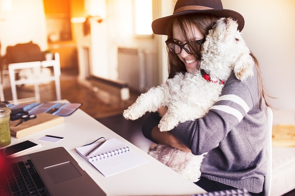 Woman and her dog read Venta blog articles for Asthma and Allergies Awareness Month 