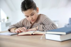 Child having difficulty studying in school with poor indoor air quality