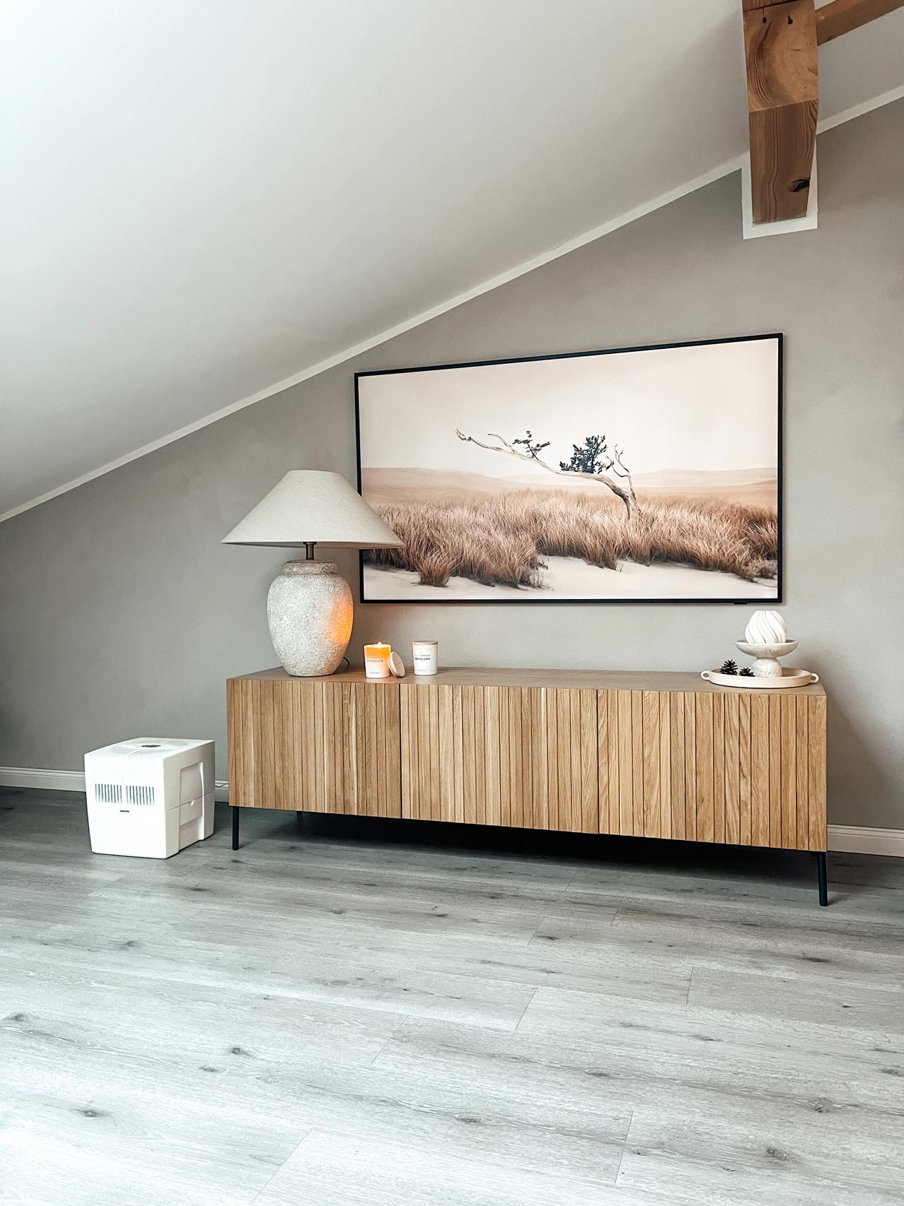 Venta humidifier Original Connect next to a large wooden chest of drawers.