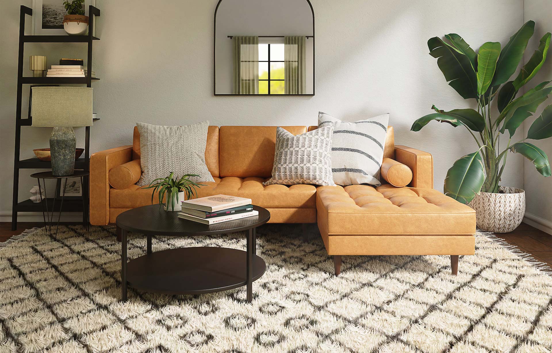 Living room with ochre couch and black round coffee table.